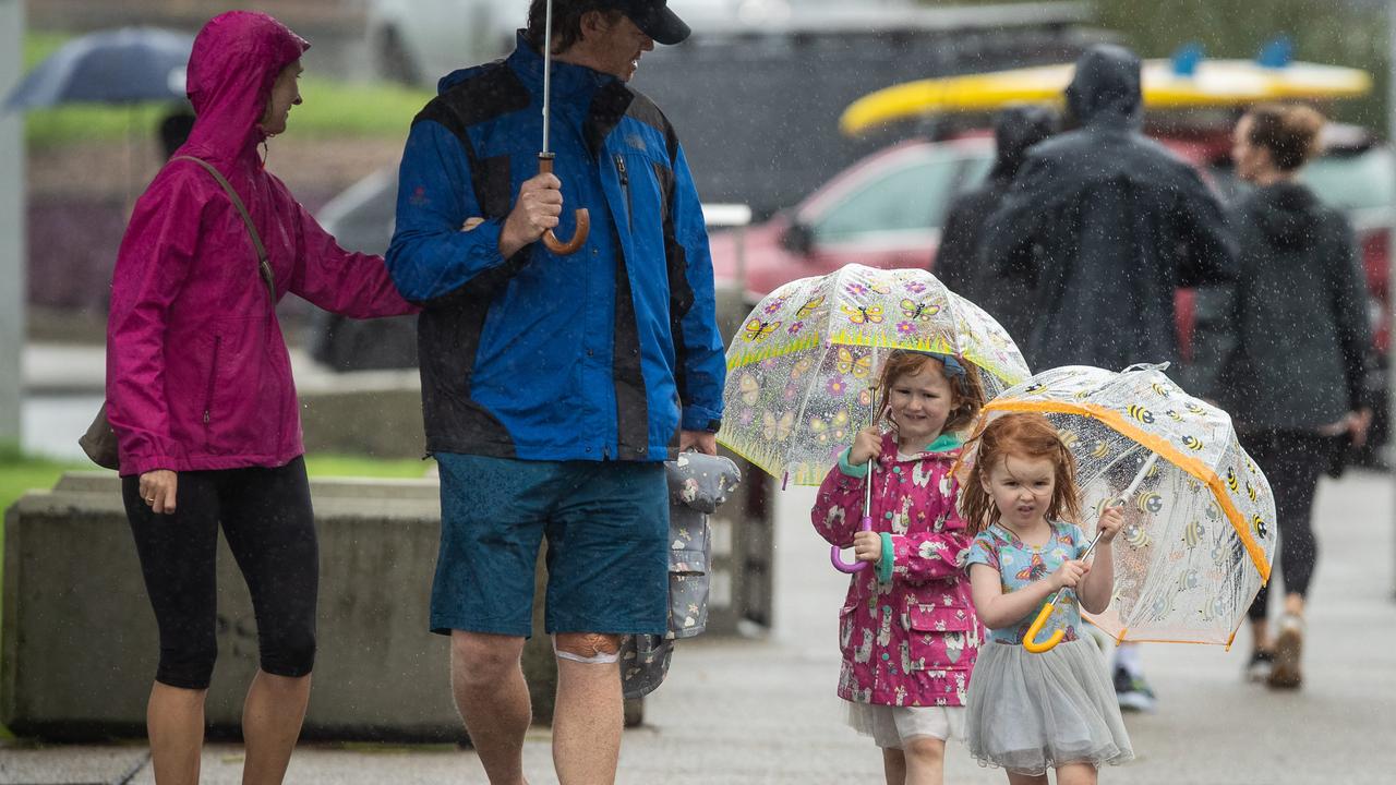 Eloise Bekker, 2, and her sister Felicity, 4, were out exploring Bondi amid the big wet. Picture: Julian Andrews