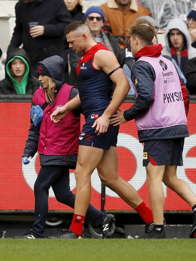 Steven May is helped from the field after being injured against Geelong.