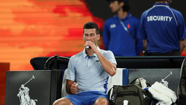 Novak Djokovic hydrates as he takes a break during his fourth round clash. Picture: Getty