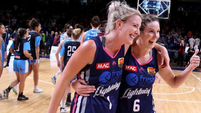 Lauren Nicholson and Stephanie Bilcavs after the Lightning won game two of the WNBL grand final series against Canberra. Picture: Kelly Barnes (AAP).