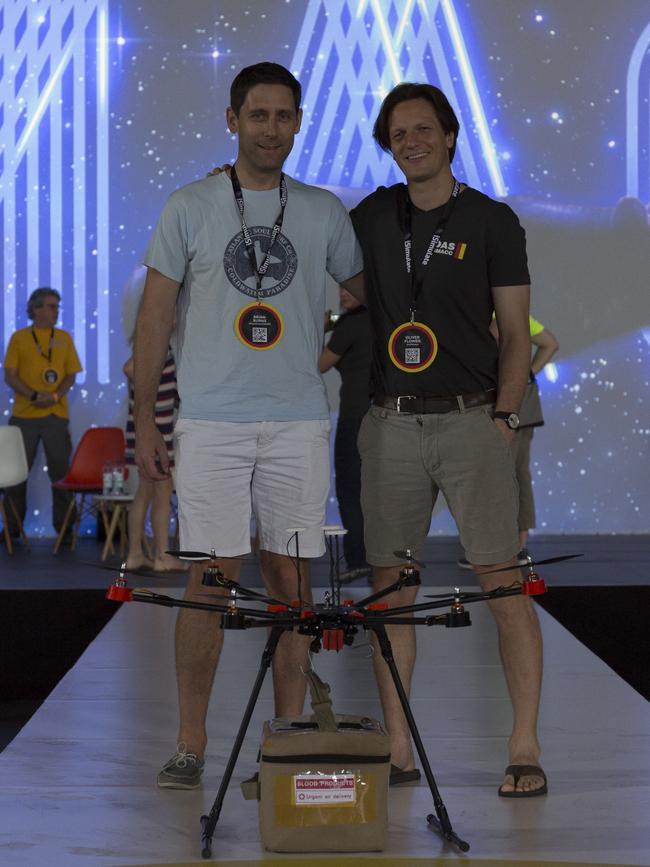 Dr Burns and Oliver Flower with the drone and blood delivery package at the conference. Picture: Supplied