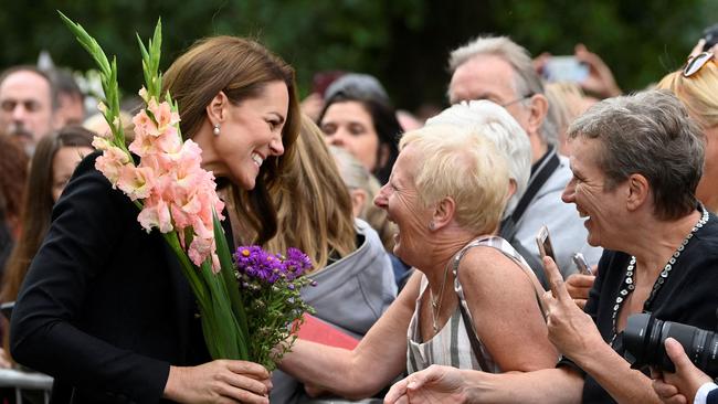 Catherine, Princess of Wales receives flowers as she chats with wellwishers outside Norwich Gate on the Sandringham Estate. Picture: AFP