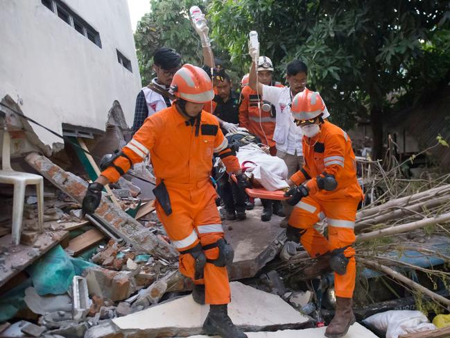 Rescue workers evacuate an injured person. Picture: AFP