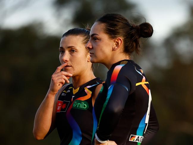 MELBOURNE, AUSTRALIA - OCTOBER 19: Kate Dempsey (left) and Monique Conti of the Tigers look dejected after a loss during the 2024 AFLW Round 08 match between the Melbourne Demons and the Richmond Tigers at Casey Fields on October 19, 2024 in Melbourne, Australia. (Photo by Michael Willson/AFL Photos via Getty Images)