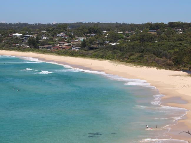 Police set up a crime scene on Mollymook Beach after flesh washed up on the shore.