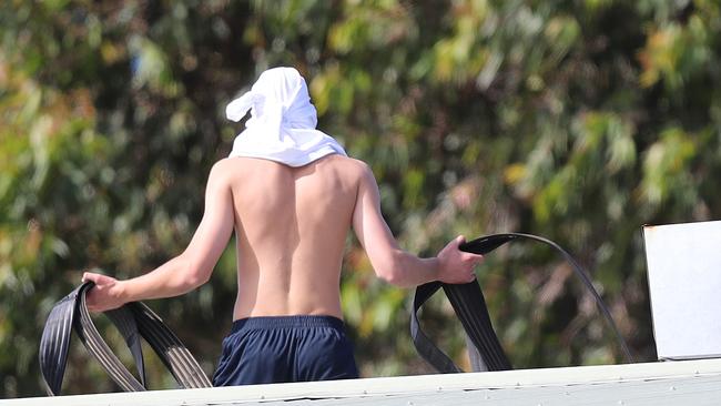 A youth with a fire hose on the roof of Parkville Juvenile Justice Centre. Picture: Alex Coppel