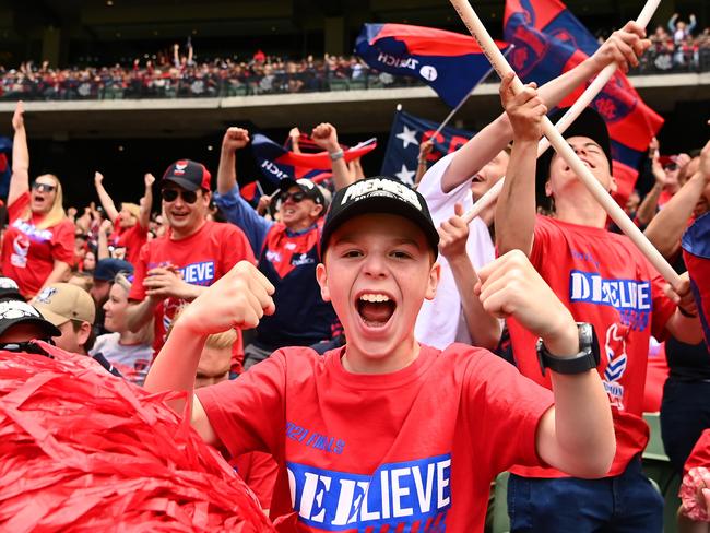 Fans celebrate watching a replay of the grand final during the Melbourne Demons AFL Premiership Celebration at Melbourne Cricket Ground on December 5. Picture: Getty