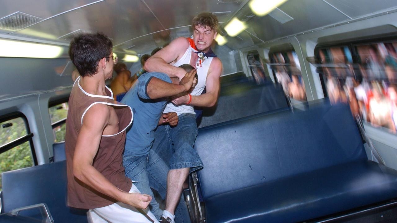 An angry mob enters a train at Cronulla Railway Station to attack two men of Middle Eastern appearance, at the height of the 2005 riots. 