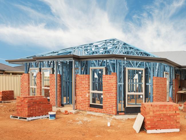 New residential construction home from brick with metal framing against a blue sky; real estate Australian generic suburban homes