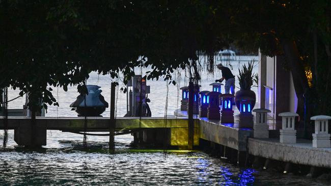 A law enforcement officer is seen at the edge of a property belonging to US producer and musician Sean "Diddy" Combs on Star Island in Miami Beach.