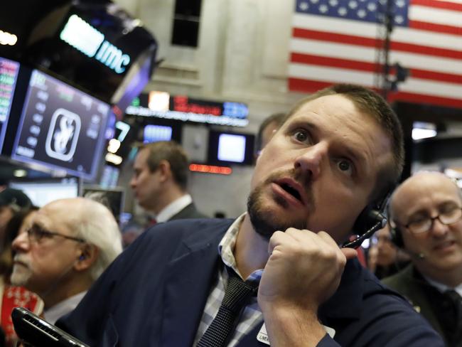 FILE- In this Oct. 19, 2018, file photo trader Michael Milano works on the floor of the New York Stock Exchange. The U.S. stock market opens at 9:30 a.m. EDT on Thursday, Oct. 25. (AP Photo/Richard Drew, File)