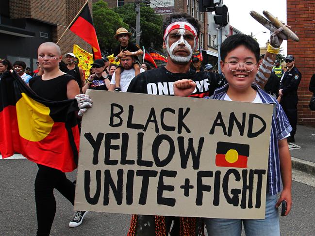 Protesters are seen at an Invasion Day rally in Redfern, Sydney, Friday, January 26, 2018. (AAP Image/Danny Casey)