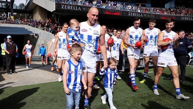 Cunnington ran through the banner with his kids in first AFL game following his cancer battle. Picture: James Elsby/AFL Photos