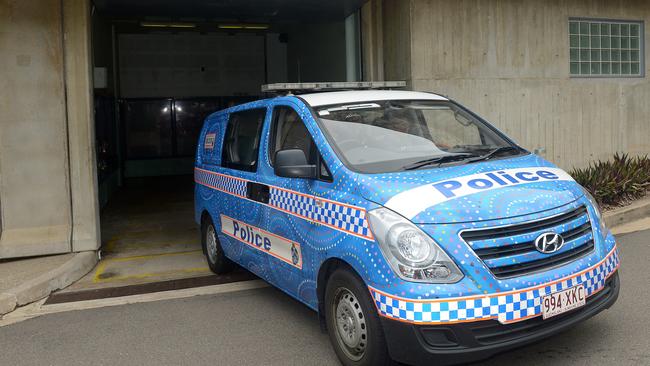 A Palm Island man is driven into the watch house by police. He is on a murder charge following an incident on the island.