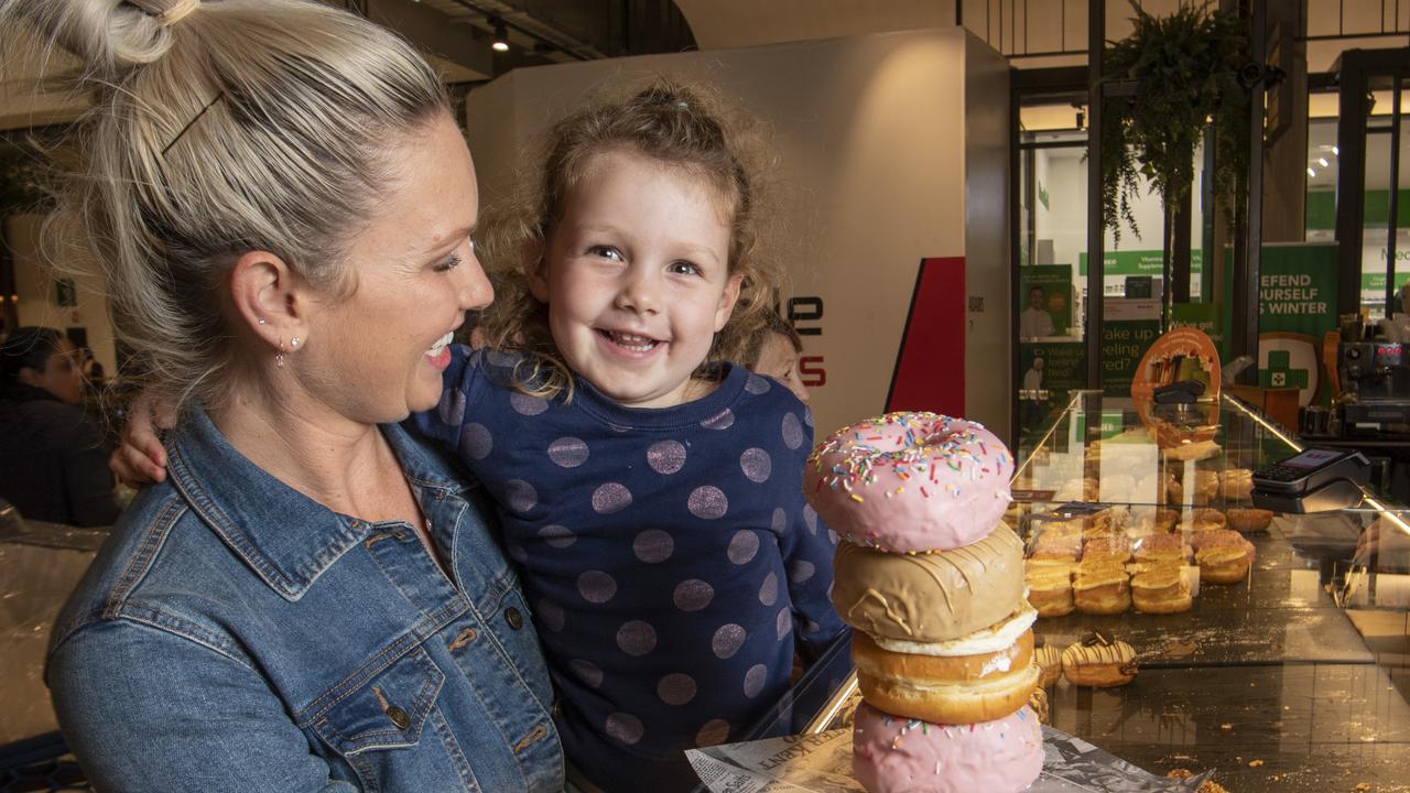 Summer Simon tries out the doughnuts at Brooklyn Donut with her mother Roxy. Picture: Nev Madsen.