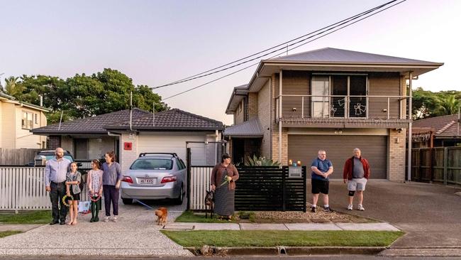 Residents of Nearra Street in Deagon, Queensland, gather outside their houses to commemorate Anzac Day. Picture: Richard Walker