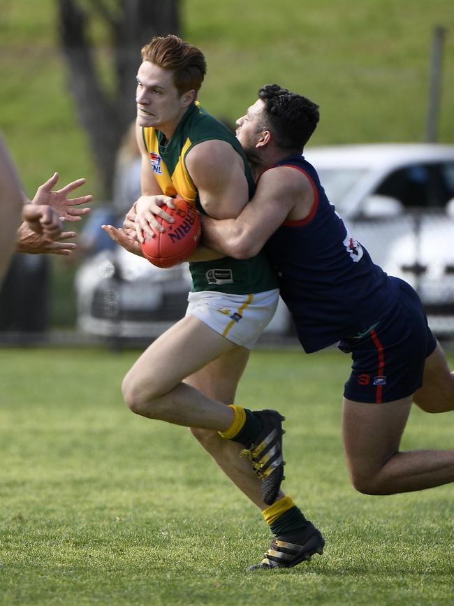 Nick Gay is tackled by Mladen Josic during the SFNL Div 3 Grand Final. Picture: Andy Brownbill.