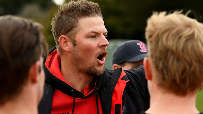 Romsey coach Justin Sherman talks to his players. Picture: Josh Chadwick