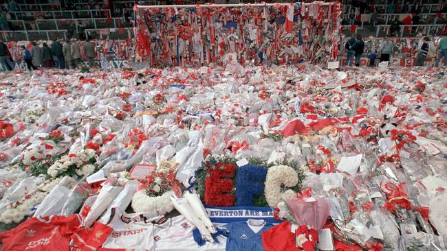 FILE - In this April 17, 1989 file photo, floral tributes are placed by soccer fans at the 'Kop' end of Anfield Stadium in Liverpool, England, 2 days after the Hillsborough April 15 tragedy when fans surged forward during the cup semifinal between Liverpool and Nottingham Forest at Hillsborough Stadium killing 96 people. British prosecutors on Wednesday June 28, 2017, are set to announce whether they plan to lay charges in the deaths of 96 people in the Hillsborough stadium crush _ one of Britainâ€™s worst-ever sporting disasters. (AP Photo/ Peter Kemp, file)