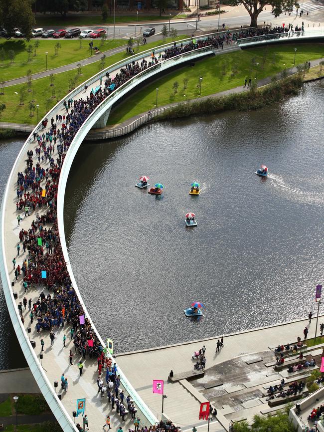 Hundreds of kids cross the footbridge for the 2015 Come Out Children’s Festival opening. Picture: Tait Schmaal