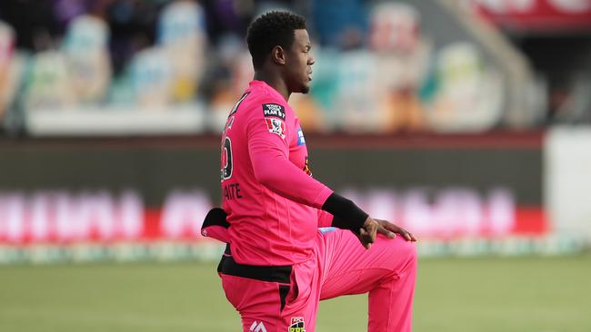 Carlos Brathwaite takes the knee for Sydney Sixers before a BBL match in Hobart last year Picture: Getty Images