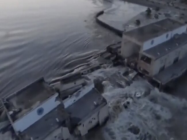 Aerial footage of water surging through the Kherson dam.