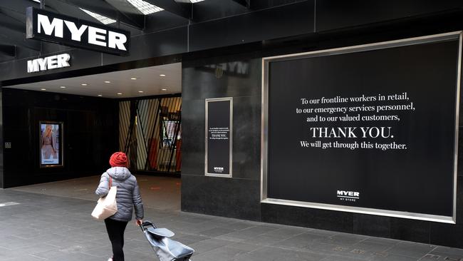 A pedestrian walks past Myer Department Store.