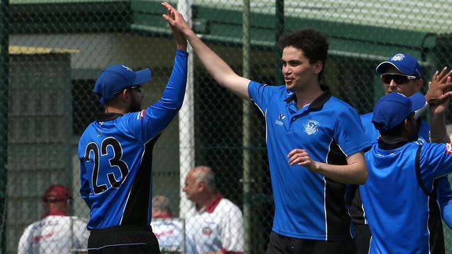 Sean McNicholl celebrates a wicket with his Greenvale teammates. Picture: Hamish Blair