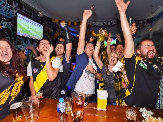 Richmond supporters celebrate the win at The G Bar on Swan St. Picture: Tony Gough