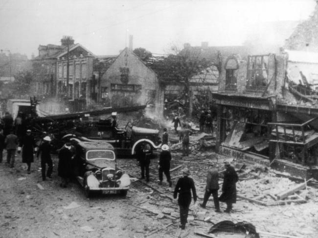 Firefighters and emergency crews clean up buildings damaged by a V1 bomb in London.