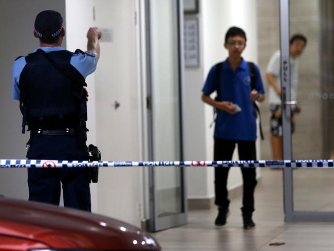 Residents are directed away from the crime scene at the Auburn unit block where Emad Sleiman was shot last night. Picture: John Grainger