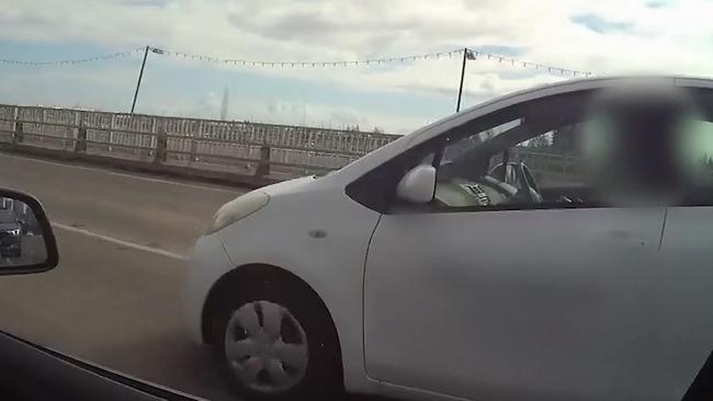 Look mum, no hands! A young driver caught by police using her mobile phone while crossing the Sundale Bridge.