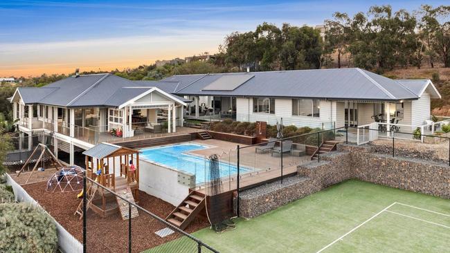 The seven-bedroom home has a pool, tennis court and playground.