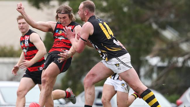 Football. TSL. Lauderdale V Tigers. Nathan Oakes (Lauderdale) under pressure from Tiger Marcus Gardner. Picture: NIKKI DAVIS-JONES