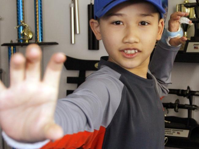 Moshe Kai Cavalin (10) strikes a martial arts position as he poses for photos at his home studio in Downey, California 02/05/2008. Cavalin at age 11 become the youngest person ever to earn an Associate in Arts Degree from the East Los Angeles College and now at age 14 is poised to graduate with honours from UCLA in late 2012.