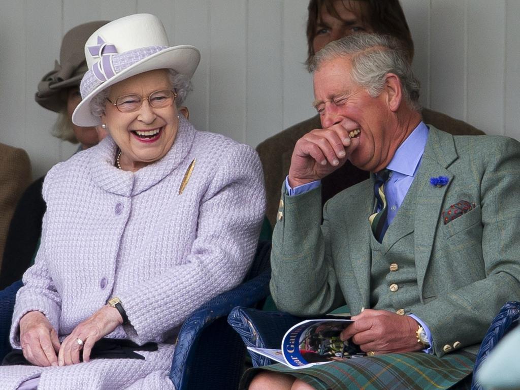 2012: The Queen and Prince Charles laugh while watching the children’s sack race at the 2012 Braemar Highland Gathering in Braemar, Scotland. Picture: Indigo/Getty Images