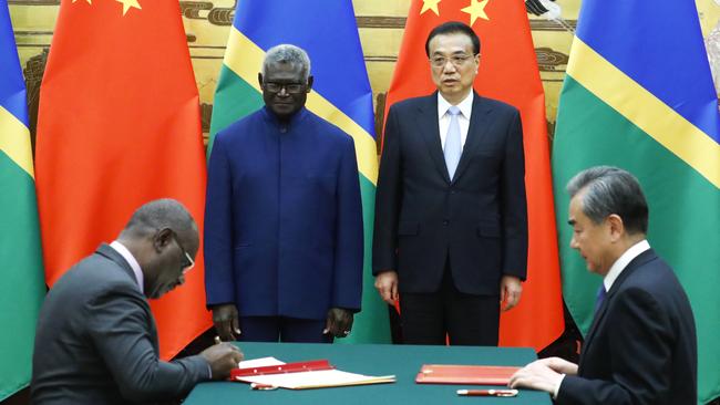 (L-R) Solomon Islands Prime Minister Manasseh Sogavare, Solomon Islands Foreign Minister Jeremiah Manele, Chinese Premier Li Keqiang and Chinese State Councillor and Foreign Minister Wang Yi attend a signing ceremony at the Great Hall of the People in 2019 in Beijing.