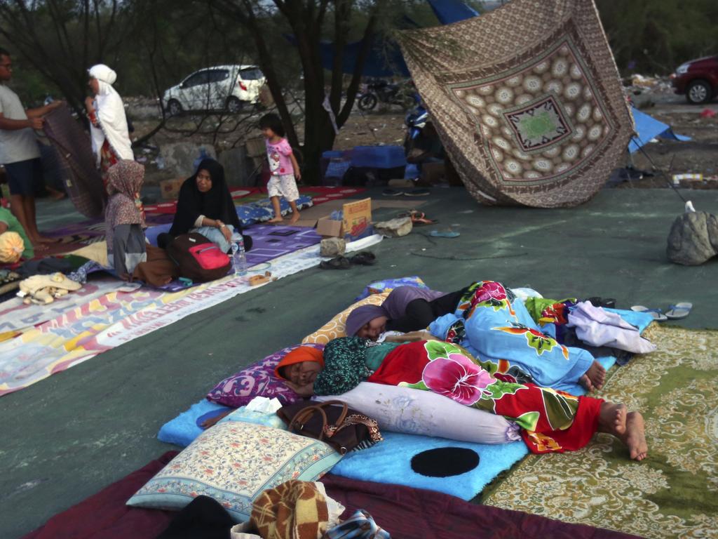 Villagers gather at a temporary shelter following earthquakes and a tsunami in Palu. Picture: AP