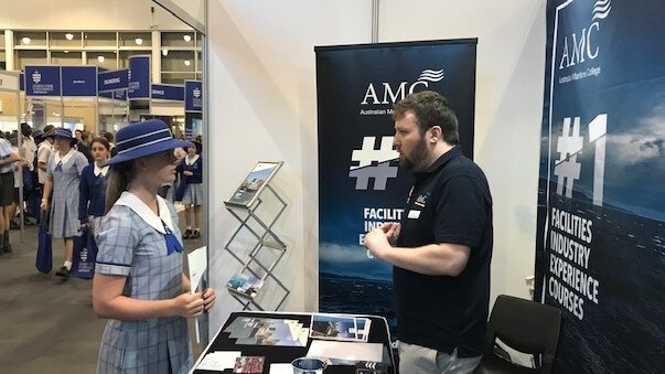 A high-school student inquires at the Australian Maritime College stand at a Townsville careers expo