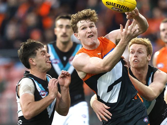 Giants Tom Green handballs under pressure from Port Adelaide's Zak Butters and Willem Drew during the AFL Round 14 AFL match between the GWS Giants and Port Adelaide Power at Engie Stadium, Sydney on June 16, 2024.. Photo by Phil Hillyard(Image Supplied for Editorial Use only - **NO ON SALES** - Â©Phil Hillyard )