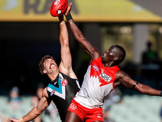 ADELAIDE, AUSTRALIA - AUGUST 29: Scott Lycett of the Power and Aliir Aliir of the Swans compete in a ruck contest during the 2020 AFL Round 14 match between the Port Adelaide Power and the Sydney Swans at Adelaide Oval on August 29, 2020 in Adelaide, Australia. (Photo by Matt Turner/AFL Photos via Getty Images)