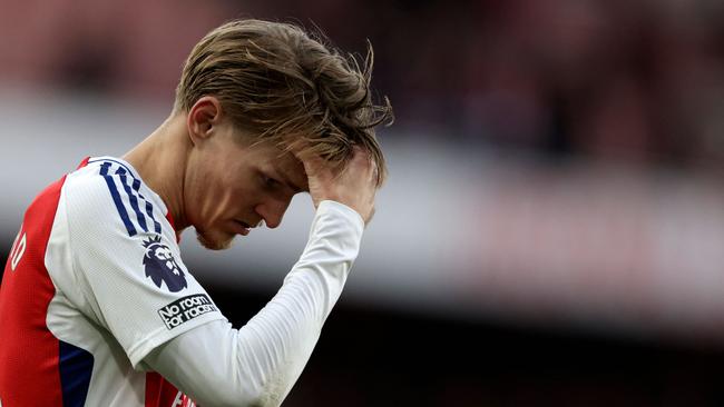 Arsenal's Norwegian midfielder #08 Martin Odegaard reacts after the English Premier League football match between Arsenal and West Ham United at the Emirates Stadium in London on February 22, 2025. West Ham won the match 1-0. (Photo by Ian Kington / IKIMAGES / AFP) / RESTRICTED TO EDITORIAL USE. No use with unauthorized audio, video, data, fixture lists, club/league logos or 'live' services. Online in-match use limited to 45 images, no video emulation. No use in betting, games or single club/league/player publications.