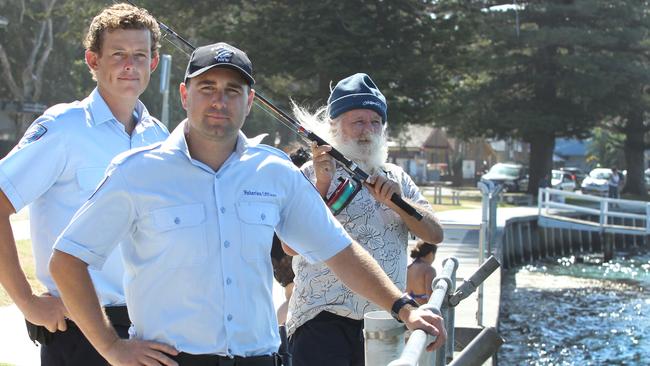 DPI Fisheries officers Jai Settree and Ben Travis with local fisherman Gary Jones at The Entrance waterfront. Picture: Mark Scott