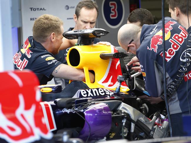 2015 Australian Grand Prix Thursday. Like surgeons, Red Bull Racing mechanics operate on the race car of Daniel Ricciardo. Picture: David Caird.