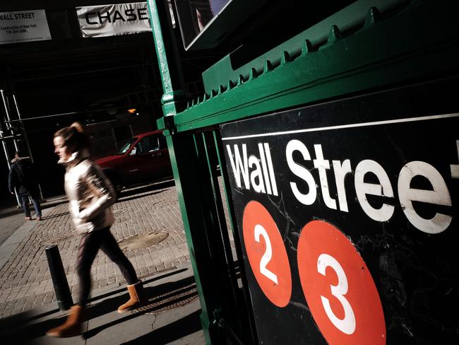 NEW YORK, NEW YORK - MARCH 08: People walk along Wall Street near the New York Stock Exchange (NYSE) on March 08, 2022 in New York City. The Dow was up slightly in morning trading as the Russian invasion of Ukraine continues to unsettle global markets.   Spencer Platt/Getty Images/AFP == FOR NEWSPAPERS, INTERNET, TELCOS & TELEVISION USE ONLY ==