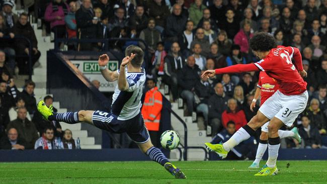 Marouane Fellaini (R) shoots past West Bromwich Albion.