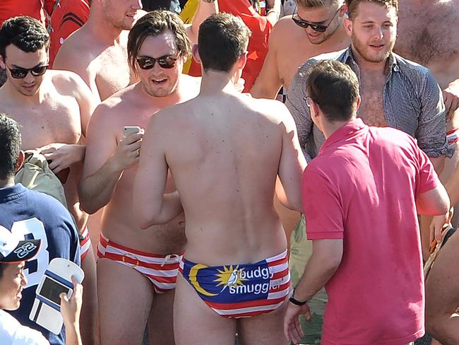 This picture taken on October 2, 2016 shows spectators with swimwear bearing a Malaysian flag during the Formula One Malaysian Grand Prix in Sepang. The spectators were arrested around the time the race ended on October 2 and were being investigated for 