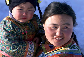 Bond ... a Mongolian mother holds her child / Reuters