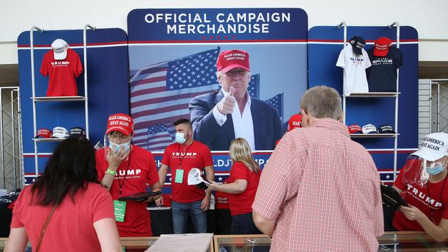 Merchandise vendors wear masks while selling campaign gear during a rally for U.S. President Donald Trump at the BOK centre in Tulsa, Oklahoma.