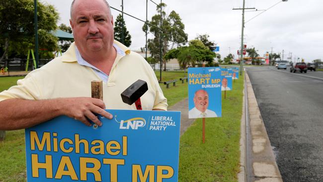 State Member for Burleigh Michael Hart MP outside is office at Miami , replacing several campaing signs that were stolen/knocked down on Sat night.